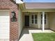 Close up of a home's exterior entrance, featuring a black front door and brick and siding accents at 1702 Juniper Ln, Greenwood, IN 46143