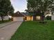 Charming brick home with a two-car garage, well-maintained lawn, and inviting curb appeal at 1702 Juniper Ln, Greenwood, IN 46143