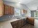 Well-lit kitchen showcasing wooden cabinets and stainless steel appliances at 1702 Juniper Ln, Greenwood, IN 46143