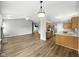 Open living room flowing into the kitchen, featuring hardwood floors, stainless appliances, and a center island at 1702 Juniper Ln, Greenwood, IN 46143