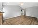 Open-concept living room featuring neutral paint and wood floors at 1702 Juniper Ln, Greenwood, IN 46143