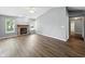Spacious living room with a brick fireplace and hardwood flooring, offering plenty of natural light at 1702 Juniper Ln, Greenwood, IN 46143