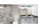 Modern bathroom featuring a double sink vanity and a walk-in shower with mosaic tile at 1809 S H St, Elwood, IN 46036