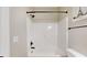 Bright white tiled bathroom with a shower featuring a black shower head and fixtures at 1809 S H St, Elwood, IN 46036