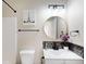 Bathroom showcases a framed mirror and patterned backsplash adjacent to white bathtub at 1809 S H St, Elwood, IN 46036