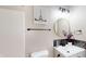 The bathroom showcases a framed mirror, unique patterned backsplash and matte black hardware at 1809 S H St, Elwood, IN 46036