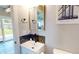 Stylish half bathroom featuring a modern vanity with sleek fixtures and unique geometric tile backsplash at 1809 S H St, Elwood, IN 46036