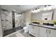 Modern bathroom featuring a double sink vanity and a walk-in shower with mosaic tile at 1809 S H St, Elwood, IN 46036