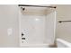 Clean, bright bathroom with a white tub and shower combo at 1809 S H St, Elwood, IN 46036
