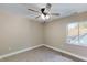Bedroom with neutral walls, carpet, ceiling fan, and a large window at 1809 S H St, Elwood, IN 46036