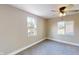 Bedroom with neutral walls, carpet, and two large windows at 1809 S H St, Elwood, IN 46036