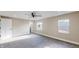 A bedroom with gray carpet, two windows, and white trim and doors at 1809 S H St, Elwood, IN 46036