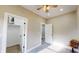 Carpeted bedroom with white trim, neutral paint, and multiple doors showcasing great layout at 1809 S H St, Elwood, IN 46036