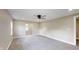 A bedroom with gray carpet, white trim, a ceiling fan, and neutral walls at 1809 S H St, Elwood, IN 46036