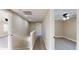 A carpeted hallway leads to various rooms, including a bedroom and the stairway at 1809 S H St, Elwood, IN 46036
