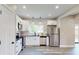 Bright kitchen with stainless steel appliances, modern white cabinets, and black countertops at 1809 S H St, Elwood, IN 46036
