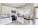 Bright kitchen with white cabinets, stainless steel appliances, and granite countertops at 1809 S H St, Elwood, IN 46036