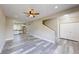 Bright, open-concept living room with modern flooring, stairs, and access to the kitchen at 1809 S H St, Elwood, IN 46036