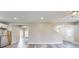 Bright, open-concept living room with modern flooring, stairs, and access to the kitchen at 1809 S H St, Elwood, IN 46036