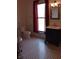 Bathroom featuring tiled floors, a decorative mirror, and a modern vanity at 189 S Jefferson St, Martinsville, IN 46151