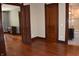 Spacious bedroom with hardwood floors, wood trim, and access to bathroom at 189 S Jefferson St, Martinsville, IN 46151