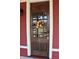Close-up of the home's stained-wood front door featuring glass panels and a decorative wreath at 189 S Jefferson St, Martinsville, IN 46151