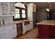Elegant kitchen with stainless appliances, granite countertops, custom cabinetry, large windows, and wooden floors at 189 S Jefferson St, Martinsville, IN 46151