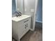 Bathroom featuring a sleek vanity with dark hardware, a mirror, and wood-look floors at 19236 Fox Chase Dr, Noblesville, IN 46062