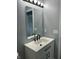 Bathroom featuring a sleek vanity with dark hardware, a mirror, and modern lighting fixtures at 19236 Fox Chase Dr, Noblesville, IN 46062