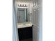 Neutral half bathroom with black vanity and modern fixtures at 19236 Fox Chase Dr, Noblesville, IN 46062