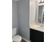 Neutral powder room with wood floors, toilet, and vanity at 19236 Fox Chase Dr, Noblesville, IN 46062