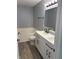 Bathroom featuring a modern double vanity, tub, and wood-look flooring at 19236 Fox Chase Dr, Noblesville, IN 46062