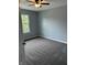 Neutral bedroom with new carpet, a ceiling fan, and a window offering natural light at 19236 Fox Chase Dr, Noblesville, IN 46062