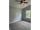 Bright bedroom featuring new carpet, a ceiling fan, and a window offering natural light at 19236 Fox Chase Dr, Noblesville, IN 46062