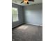 The carpeted bedroom features a ceiling fan, and a bright window at 19236 Fox Chase Dr, Noblesville, IN 46062