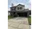 Two-story home with a brick and vinyl exterior, attached garage, and concrete driveway at 19236 Fox Chase Dr, Noblesville, IN 46062