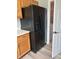 Modern kitchen featuring stainless-steel refrigerator, wood cabinets and access to laundry room at 19236 Fox Chase Dr, Noblesville, IN 46062