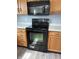 Stainless steel oven and microwave with wood cabinets and white countertop at 19236 Fox Chase Dr, Noblesville, IN 46062