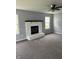 Spacious living room with gray carpet, painted brick fireplace, ceiling fan, and multiple windows at 19236 Fox Chase Dr, Noblesville, IN 46062