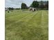 Community playground area featuring modern play structures on a neatly manicured lawn, for recreation at 19236 Fox Chase Dr, Noblesville, IN 46062