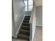 Carpeted staircase with white railings leading to the upper level of the home at 19236 Fox Chase Dr, Noblesville, IN 46062