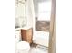 Clean bathroom featuring a classic vanity, tub, and window for natural light at 1940 N Drexel Ave, Indianapolis, IN 46218
