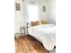 Bright bedroom featuring hardwood floors, a comfy bed, and natural light from the window at 1940 N Drexel Ave, Indianapolis, IN 46218