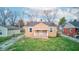 Charming bungalow-style home with a quaint front porch, grassy yard and mature trees at 1940 N Drexel Ave, Indianapolis, IN 46218