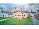 Quaint bungalow with fresh lawn, driveway, and detached garage in a neighborhood setting at 1940 N Drexel Ave, Indianapolis, IN 46218
