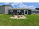 Cozy backyard featuring a brick patio with seating around a fire pit, ideal for outdoor relaxation at 1980 Bridlewood Dr, Franklin, IN 46131
