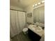 Functional bathroom featuring a shower with a white curtain, complemented by a sink and vanity area at 1980 Bridlewood Dr, Franklin, IN 46131