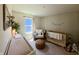 Cozy Bedroom with natural wood crib, stylish ottoman, and decor, perfect for creating a peaceful space at 1980 Bridlewood Dr, Franklin, IN 46131