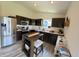 Well-appointed kitchen with modern appliances, dark cabinetry, and ample counter space for cooking and meal preparation at 1980 Bridlewood Dr, Franklin, IN 46131