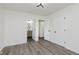 Bedroom featuring wood-look flooring, two doors, and an en-suite bathroom at 20797 Roberts Dr, Sheridan, IN 46069